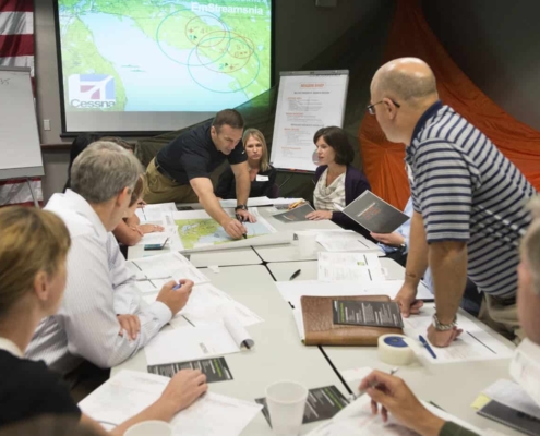 Group of employees working around a desk