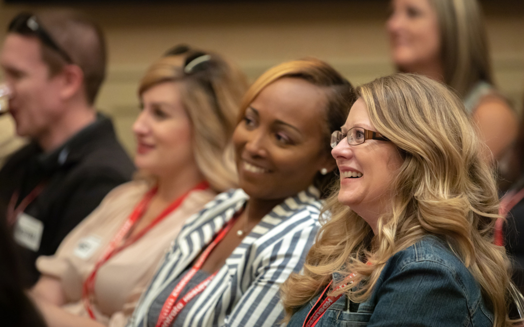 Audience Reaction Two Women Smiling Looking At Speaker