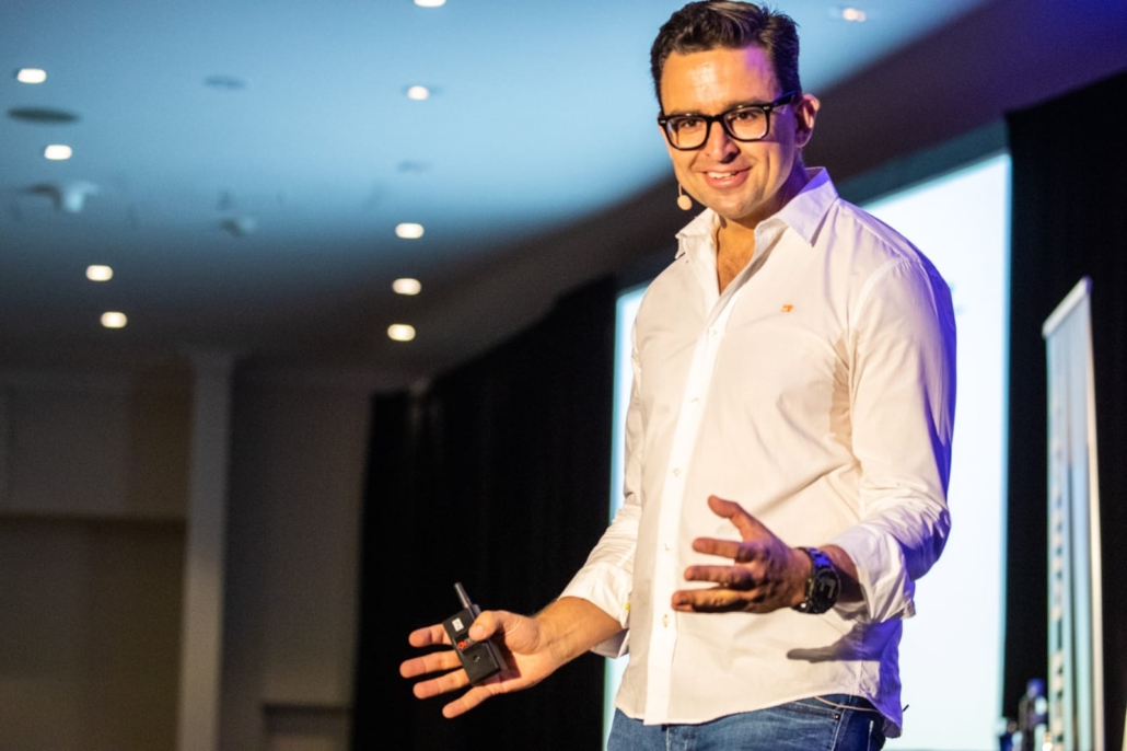 Christian Boo Boucousis speaking on stage