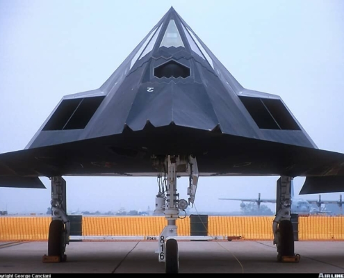 Large black aircraft sitting in runway