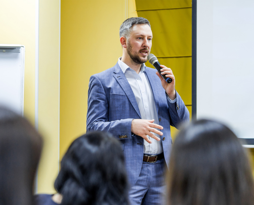 Front View Of A Man Speaking At Panel