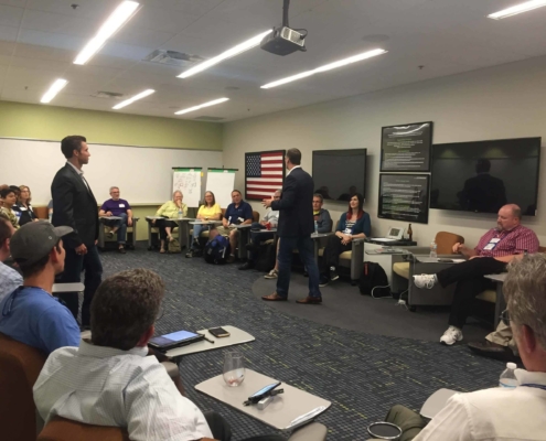 Man in suit giving presentation to his team