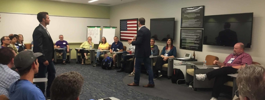 Man in suit giving presentation to his team