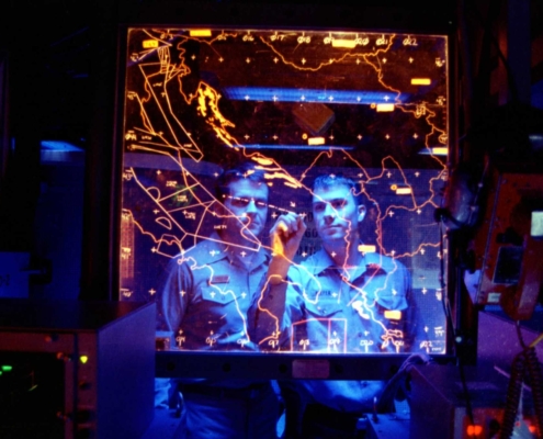 Two men staring at map and strategizing