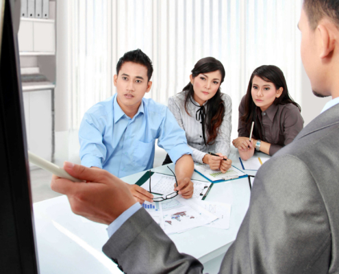 Employees listening to in-office presentation