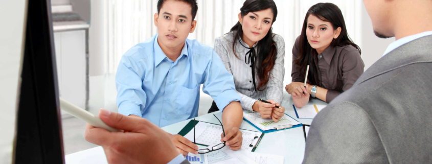 Employees listening to in-office presentation