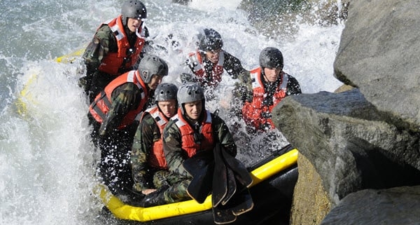 Navy SEALs rafting in dangerous waters