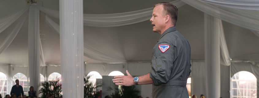 Afterburner team giving a presentation in outdoor tent
