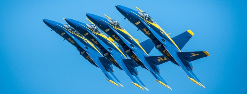 Four blue angel jets flying together