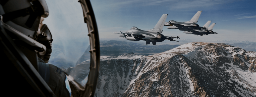 Image of group of fighter jets flying above mountains