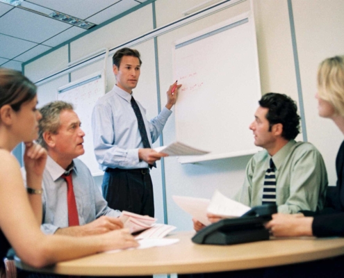 Man standing in front of room giving instructions to staff