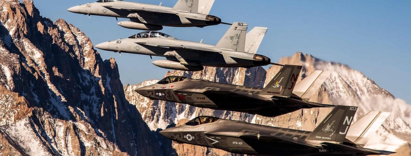 4 fighter jets flying in the mountains