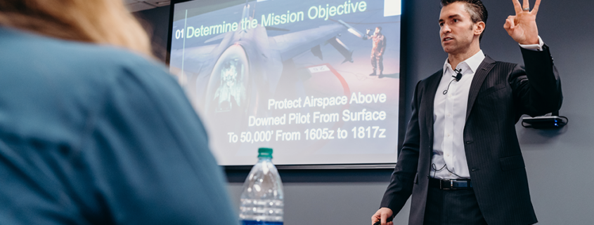 Man holds up three fingers during presentation