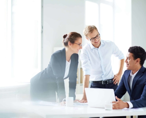 Three employees working together on a project