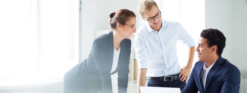 Three employees working together on a project