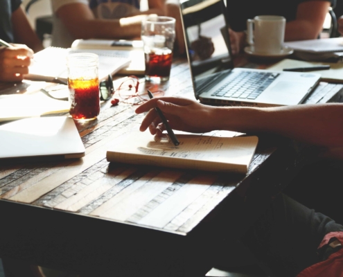 Employees huddling around a restaurant table