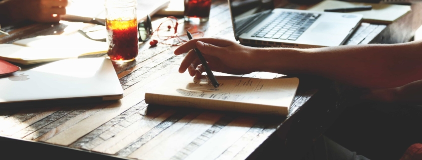 Employees huddling around a restaurant table