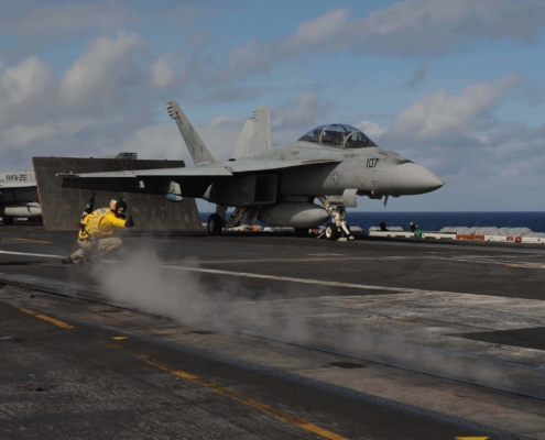 Fighter jet taking off from carrier