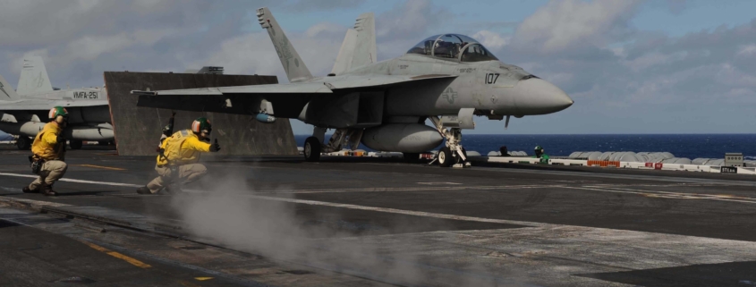 Fighter jet taking off from carrier