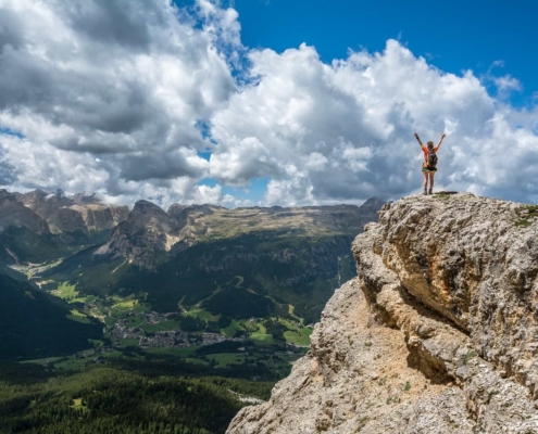 Person celebrating on a cliff side