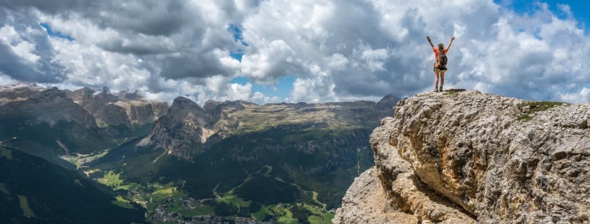 Person celebrating on a cliff side
