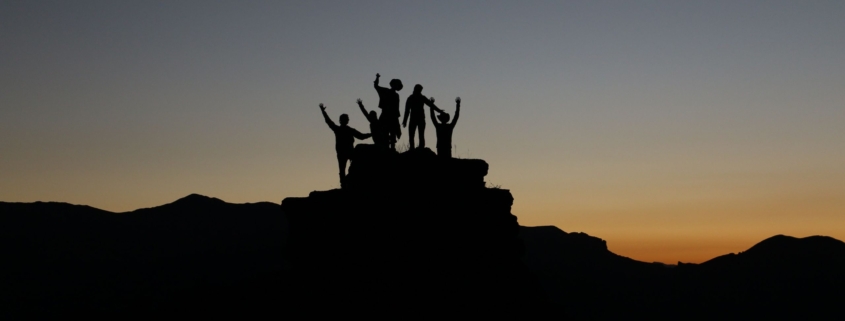 Image of people climbing a rock