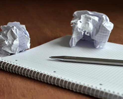 Crumbled up piece of paper on notebook