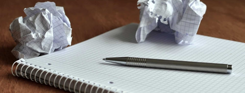 Crumbled up piece of paper on notebook