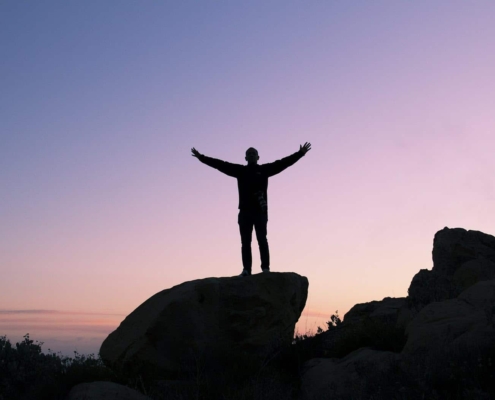 Single man standing on top of a rock