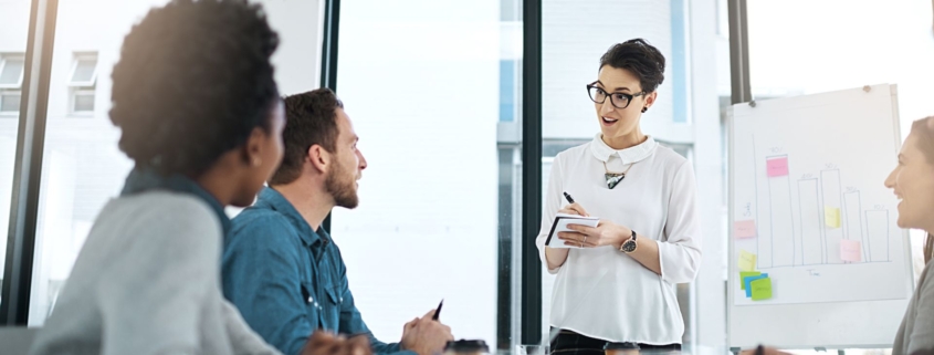 Team leader at office providing insight to her team
