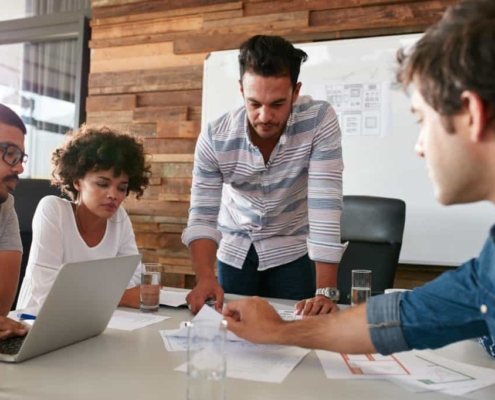 Team planning together around a desk