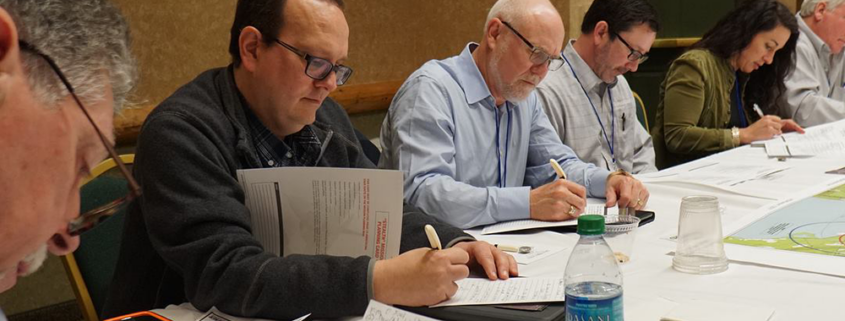 Employees participating in a debriefing session