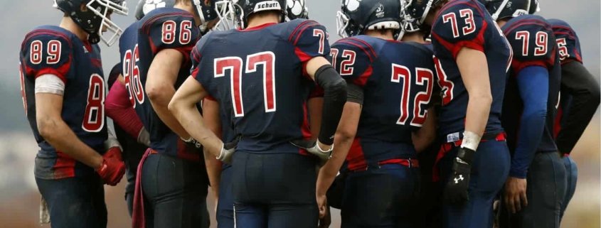 Football team huddled together