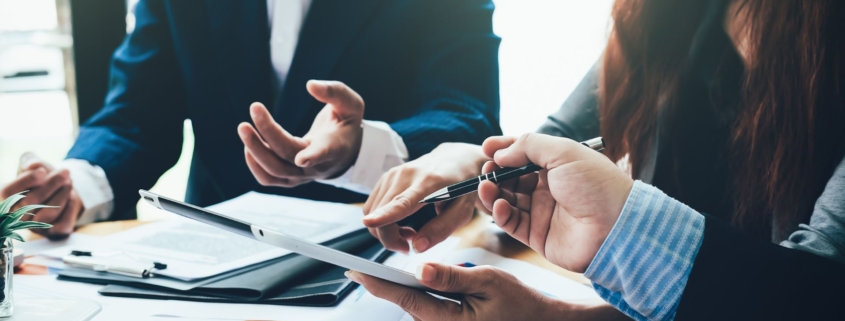 Image of team working on tablets together