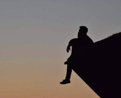 Man thinking on cliff's edge
