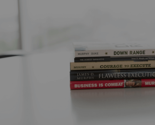 Five books stacked on a desk