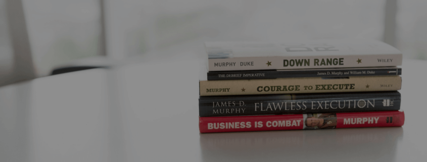 Five books stacked on a desk