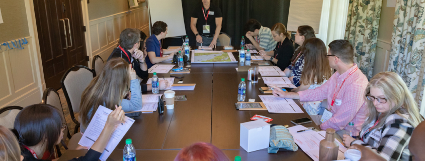 Front View Of Man In Lanyard And Business Casual Facilitating Event