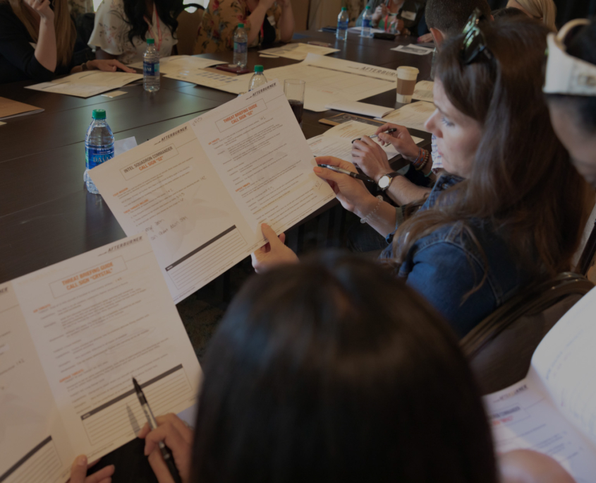 Side View Of People In Meeting Looking At Afterburner Documents