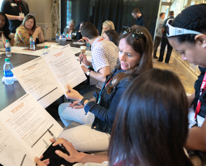Side View Of Two Women Talking About Documents