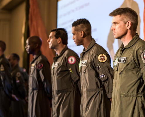 Group of Afterburner’s fighter pilot speakers standing in formation, representing elite leadership under pressure.