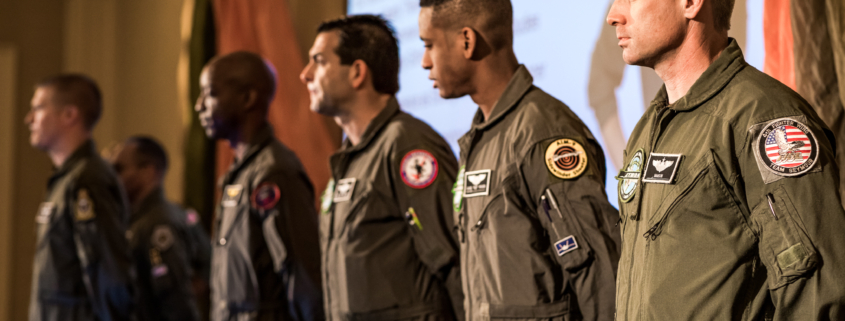 Group of Afterburner’s fighter pilot speakers standing in formation, representing elite leadership under pressure.