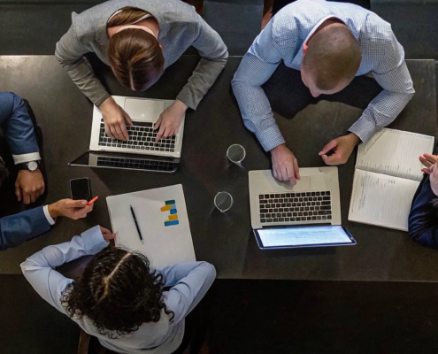 Business team running an after action review to improve project performance.