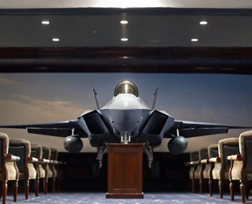 A fighter jet model on a podium, setting the stage to hire a fighter pilot speaker for business leadership.