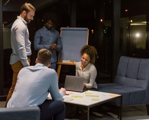 Business team collaborating on a simulation exercise for team building in a modern office.