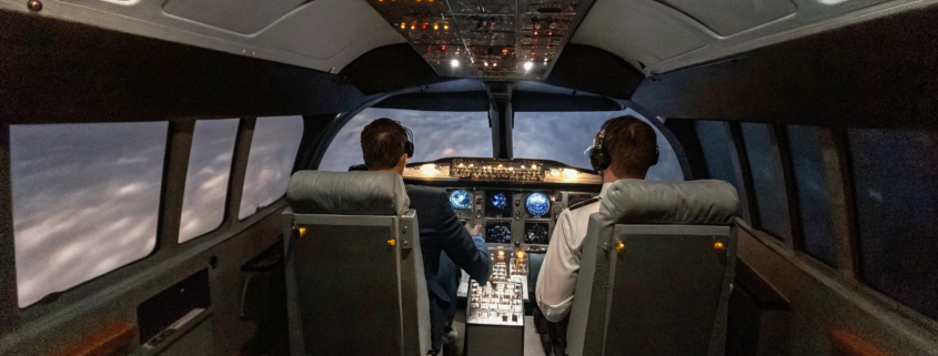Team building leadership and decision-making skills in a flight simulator cockpit.