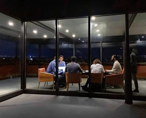 High-growth corporate team collaborating in a modern meeting room with focused energy and leadership dynamics